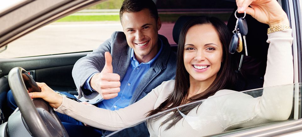 Auto tag provider holding thumbs up giving service to woman holding keys