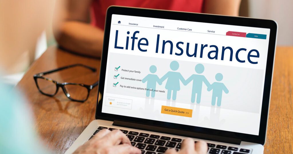person typing on a computer looking up life insurance