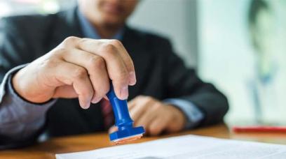 employee stamping an affidavit
