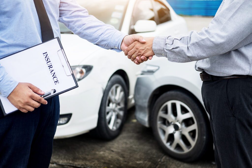 Customer shake hand with auto insurance outlet agents after agreeing to terms of insurance