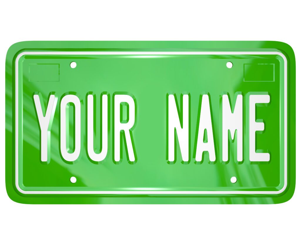 A green license vanity plate with the words Your Name to symbolize a personalized badge for your car or other vehicle